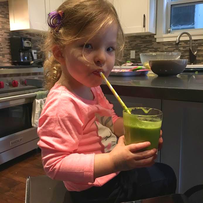 Miss Q is all smiles about her green smoothie
